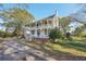 Two-story home with wraparound porch, large yard, and trees at 14299 Highway 36, Covington, GA 30014