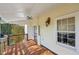 Inviting front porch with wooden flooring and ceiling fan at 14299 Highway 36, Covington, GA 30014