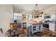 Farmhouse kitchen with butcher block island, stainless steel appliances, and white shaker cabinets at 14299 Highway 36, Covington, GA 30014