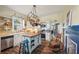 Farmhouse kitchen with butcher block island, stainless steel appliances, and white shaker cabinets at 14299 Highway 36, Covington, GA 30014