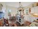 Farmhouse kitchen with butcher block island, stainless steel appliances, and white shaker cabinets at 14299 Highway 36, Covington, GA 30014
