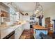 Farmhouse kitchen with butcher block island, stainless steel appliances, and white shaker cabinets at 14299 Highway 36, Covington, GA 30014