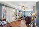 Living room with blue walls, hardwood floors, and a comfortable seating area at 14299 Highway 36, Covington, GA 30014