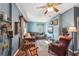 Bright living room with hardwood floors, leather seating, and a ceiling fan at 14299 Highway 36, Covington, GA 30014