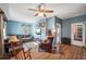 Living room with hardwood floors, a ceiling fan, and ample natural light at 14299 Highway 36, Covington, GA 30014