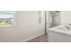 Double vanity bathroom with marble countertop and view of a bedroom at 1601 Oakbrook Pond Pl, Dacula, GA 30019