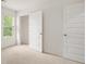 Spacious bedroom with neutral carpet, window, and closet at 1601 Oakbrook Pond Pl, Dacula, GA 30019