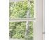 Window showing lush green trees outside at 1601 Oakbrook Pond Pl, Dacula, GA 30019