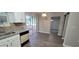 Kitchen with white cabinets, granite countertops and sliding glass door at 2991 Meadowview Ln, Lawrenceville, GA 30044