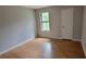 Bright bedroom with light grey walls and light brown wood-look floors at 344 Ansley Brook Dr, Lawrenceville, GA 30044