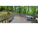 Wooden deck with table and chairs, overlooking wooded backyard at 344 Ansley Brook Dr, Lawrenceville, GA 30044