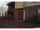 Backyard view featuring a brick wall, red double doors, and an AC unit at 4536 Mountain Creek Ne Dr, Roswell, GA 30075