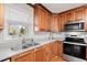 Kitchen corner with stainless steel appliances and wood cabinets at 121 Suburban Ne Dr, Kennesaw, GA 30144