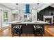 Modern kitchen with island, quartz countertops, and teal range hood at 124 Cagle Way, Hiram, GA 30141