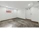 Unfinished basement with polished concrete floors, white walls, a window, and an exterior door at 3826 Ensign Dr, Chamblee, GA 30341