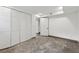 Spacious basement area with white walls, polished concrete floors, and white closet doors at 3826 Ensign Dr, Chamblee, GA 30341