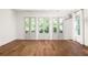 Bright living room with hardwood floors and French doors leading to a deck at 434 Selborne Way, Chattahoochee Hills, GA 30268