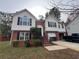 Two-story brick house with a landscaped yard and attached garage at 87 Hollinger Way, Marietta, GA 30060