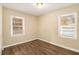 Simple bedroom with hardwood floors and two windows at 1425 Cobb Branch Dr, Decatur, GA 30032
