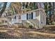 Front view of a brick ranch house with a red door and steps at 1425 Cobb Branch Dr, Decatur, GA 30032