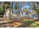 Brick ranch home with a landscaped yard and a red front door at 1425 Cobb Branch Dr, Decatur, GA 30032
