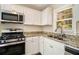 Modern kitchen with white cabinets, granite countertops, and stainless steel appliances at 1425 Cobb Branch Dr, Decatur, GA 30032