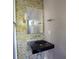 Modern bathroom with mosaic tile wall, black vessel sink, and large mirror at 1584 Tallulah Nw St, Atlanta, GA 30318