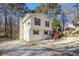 Two-story house with wooden deck, gravel driveway, and satellite dish at 3209 Dover Dr, Duluth, GA 30096