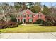 Brick two-story house with landscaped lawn and driveway at 5204 Camden Lake Nw Pkwy, Acworth, GA 30101