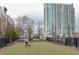 Artificial turf dog park with a person and dog playing fetch at 361 17Th Nw St # 1618, Atlanta, GA 30363