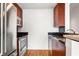 Modern kitchen with stainless steel appliances and dark wood cabinets at 361 17Th Nw St # 1618, Atlanta, GA 30363