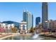 Tranquil pond with fountain, surrounded by modern buildings and trees at 361 17Th Nw St # 1618, Atlanta, GA 30363