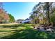 Large backyard with fire pit, playset, and wooded area at 120 Lismore Ct, Tyrone, GA 30290