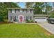 Two-story house with gray siding, pink door, and attached garage at 2722 Ashworth Cir, Snellville, GA 30078