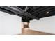 Finished basement with exposed brick wall, new flooring, and recessed lighting at 3645 Aldea Dr, Decatur, GA 30032