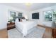 Bright bedroom with hardwood floors, plush bedding and large windows at 3645 Aldea Dr, Decatur, GA 30032