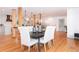 Farmhouse style dining area with hardwood floors and white chairs at 3645 Aldea Dr, Decatur, GA 30032