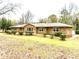 Stone house exterior with landscaping and a detached garage at 3645 Aldea Dr, Decatur, GA 30032