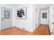 Bright hallway with hardwood floors, a door, and modern wall art at 3645 Aldea Dr, Decatur, GA 30032