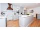 Modern kitchen with white cabinets, quartz counters, and wood floors at 3645 Aldea Dr, Decatur, GA 30032