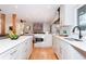 Open concept kitchen with island, white cabinets, and stainless steel appliances at 3645 Aldea Dr, Decatur, GA 30032