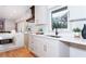 Modern kitchen with white cabinets, quartz countertops, and a copper range hood at 3645 Aldea Dr, Decatur, GA 30032