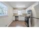Modern kitchen with white cabinets, granite counters, and stainless steel appliances at 2543 Brentwood Rd, Decatur, GA 30032