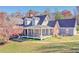 Two-story home with wraparound porch and landscaped yard at 3975 Mcconnell Rd, Cumming, GA 30028