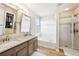 Luxurious bathroom with double vanity, soaking tub, and a walk-in shower at 11277 Musette Cir, Alpharetta, GA 30009