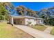 Side view of a ranch home with carport and landscaping at 4252 Lamar St, Decatur, GA 30035