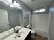 Clean bathroom with tub shower combo and dark vanity at 1244 St James Pl, Loganville, GA 30052