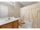 Bathroom with plaid wallpaper, tub, and wood vanity at 470 Gray Herron Ct, Lawrenceville, GA 30044