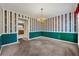 Dining room with striped wallpaper, chandelier, and green wainscoting at 470 Gray Herron Ct, Lawrenceville, GA 30044