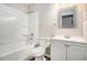 Clean bathroom with white vanity, tub, and shower at 676 Tarkington S Rd, Stone Mountain, GA 30088